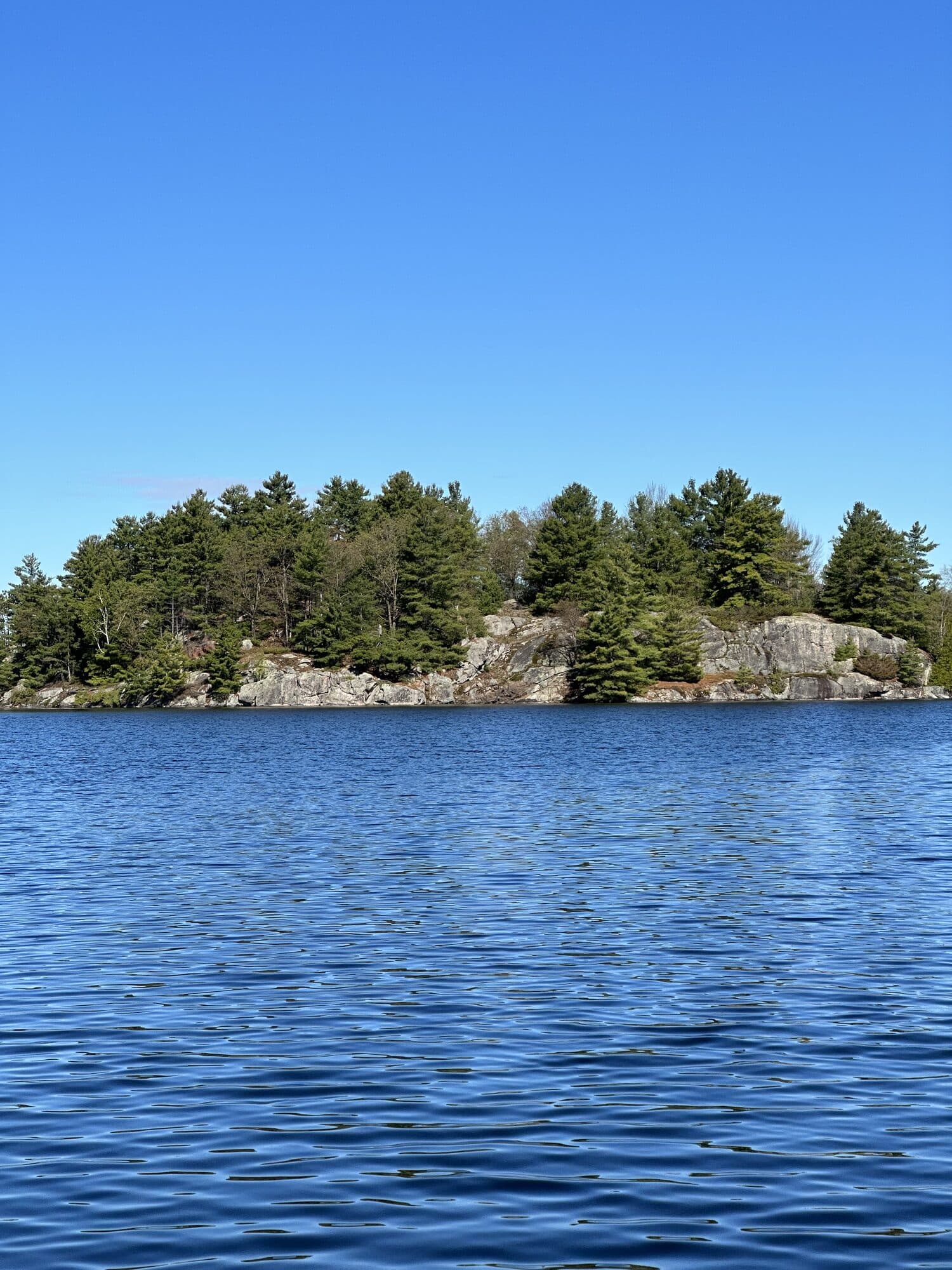 Rocky island on a calm Ontario lake far from Muskoka crowds