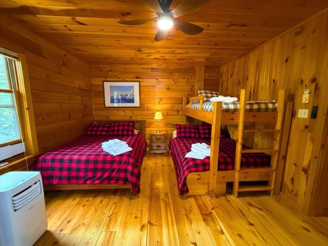 Upper left bedroom with a double bed and a double with single bunk above