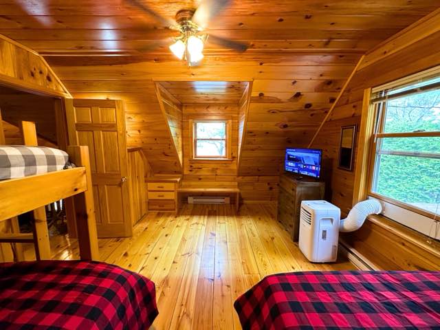 Upper right bedroom with two double beds and a single
